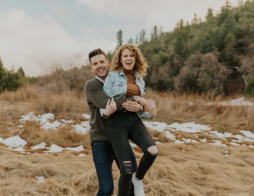 A man and woman hugging at Doane Pond at Palomar Mountain