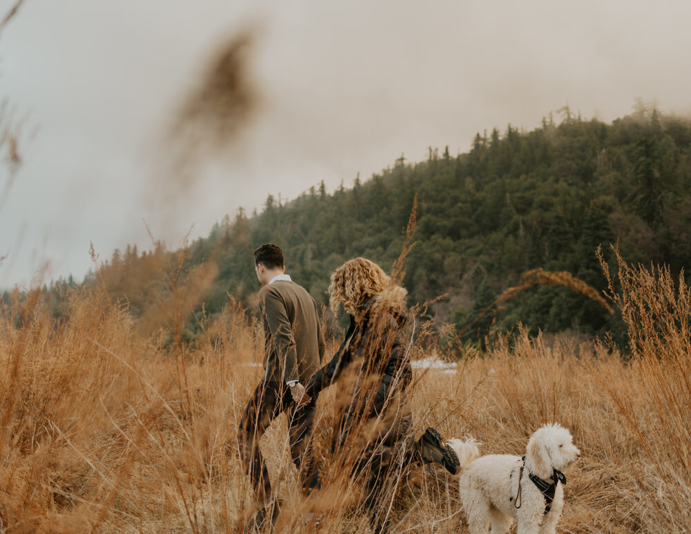 An engaged couple and their dog at Doane Pond at Palomar Mountain