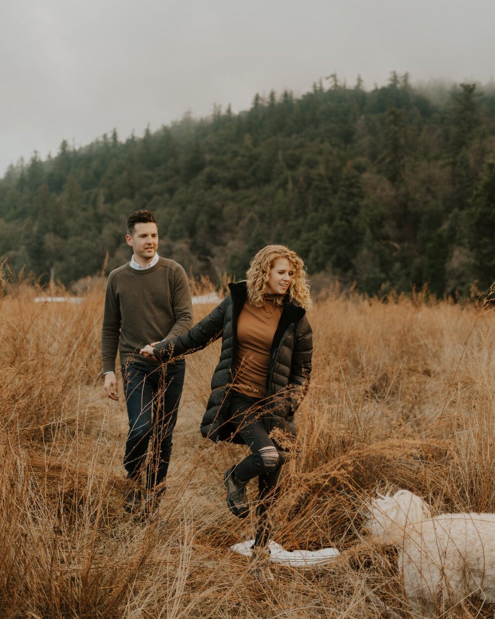 An engaged couple and their dog at Doane Pond at Palomar Mountain