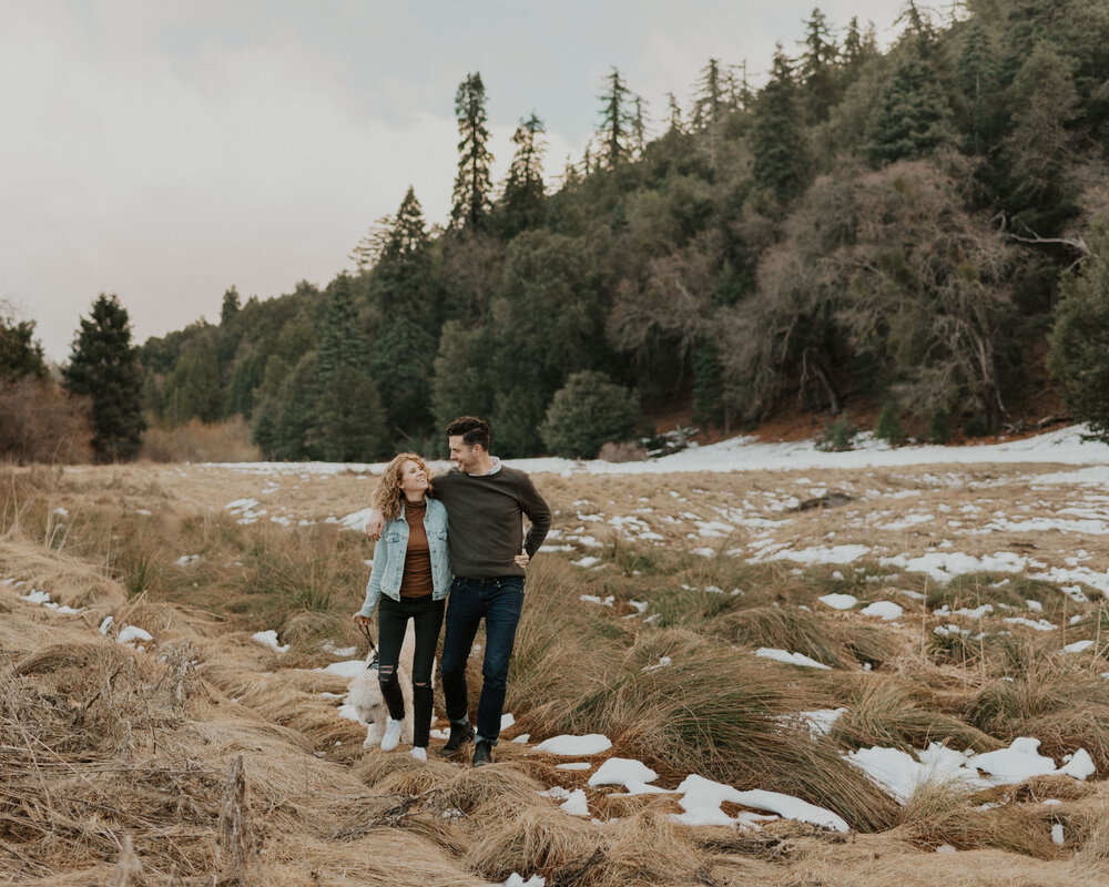 A man and woman walking at Doane Pond at Palomar Mountain