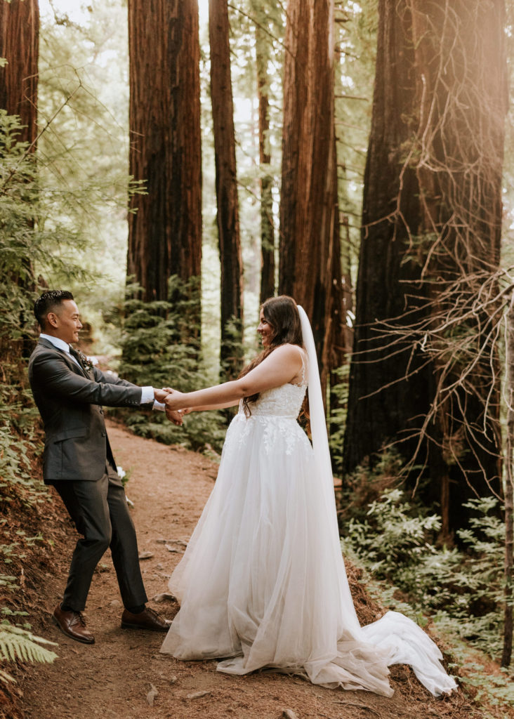 A bride and groom dancing in the redwoods in Big Sur during their elopement