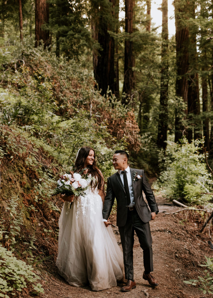 A bride and groom walking during their elopement in Big Sur.