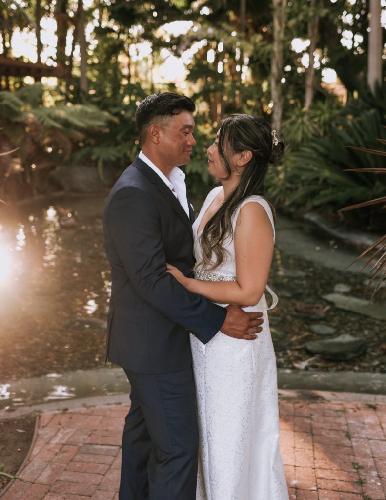 A bride and groom embracing during their elopement at the Bahia Resort Hotel in San Diego California.