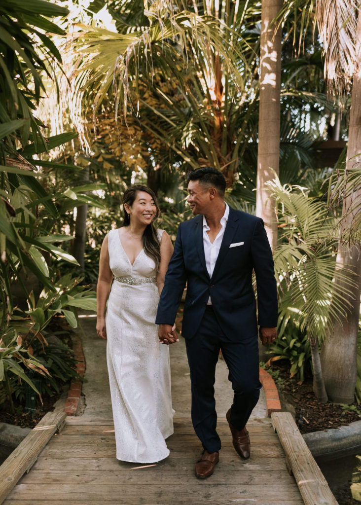 A bride and groom walking during their elopement at the Bahia Resort Hotel in San Diego California.
