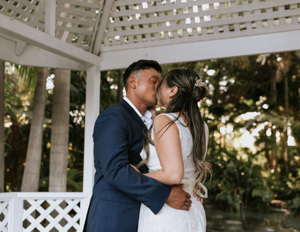 A bride and groom kissing at their elopement at the Bahia Resort Hotel in San Diego California.