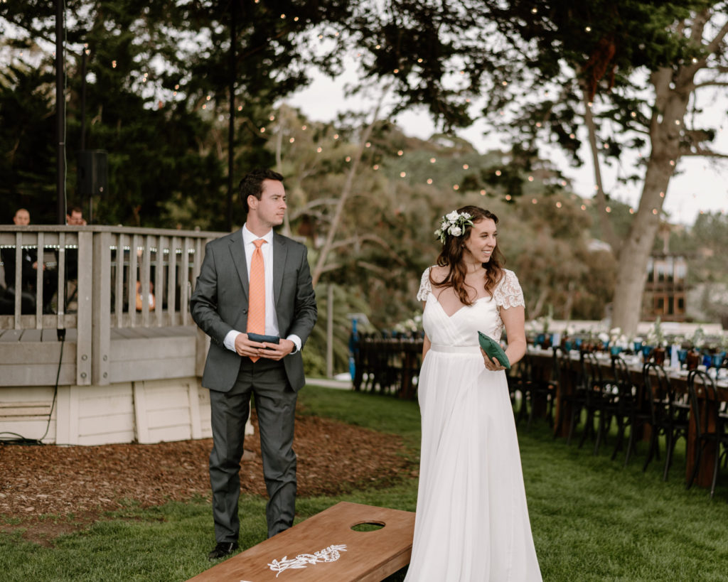 A bride and groom playing a game at their wedding at Martin Johnson House in La Jolla, California.