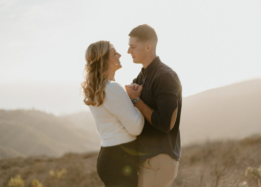 A couple walking the trails during their Top of the World engagement session in Laguna Beach.