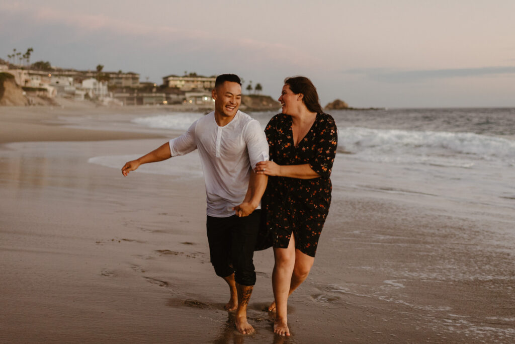 A couple walking during their Victoria Beach engagement session.