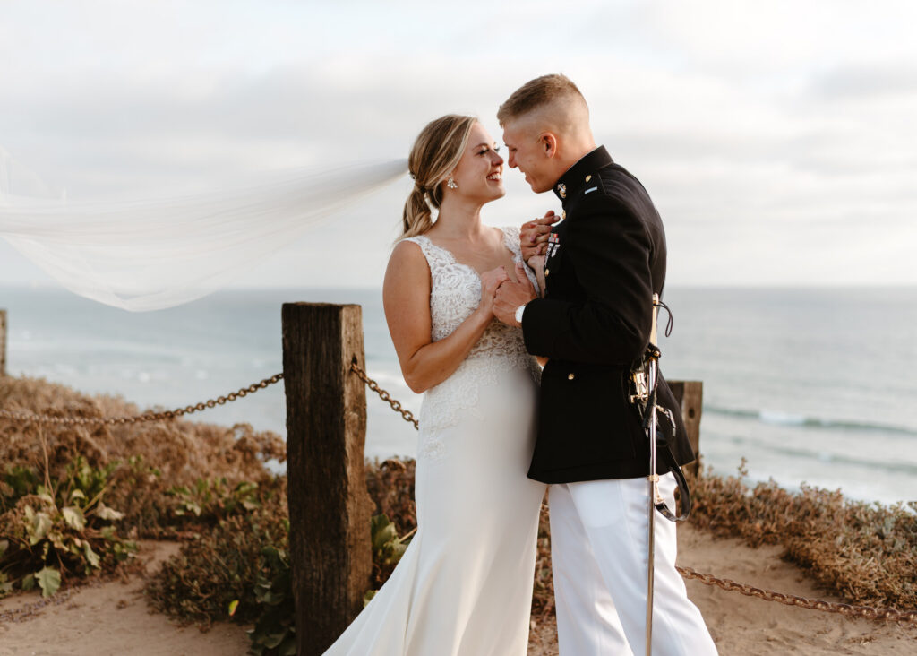 A couple taking photos during their Del Mar wedding.