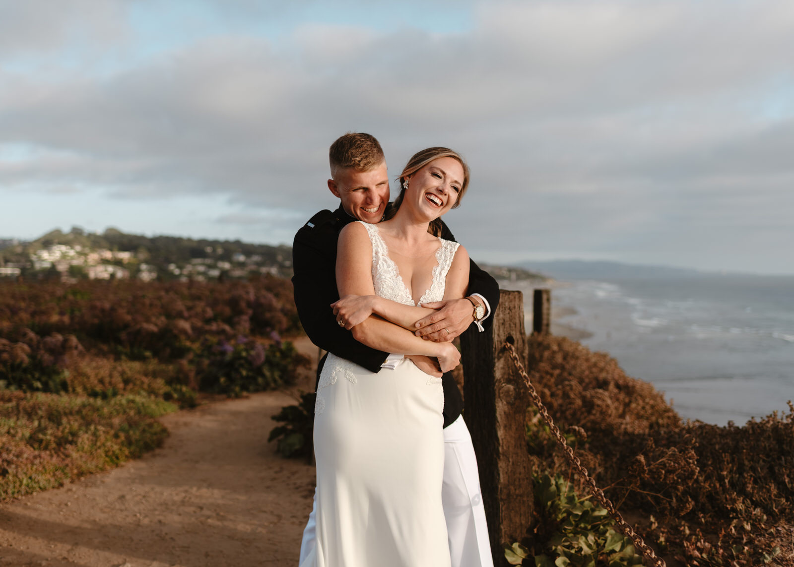A couple taking photos during their Del Mar wedding.