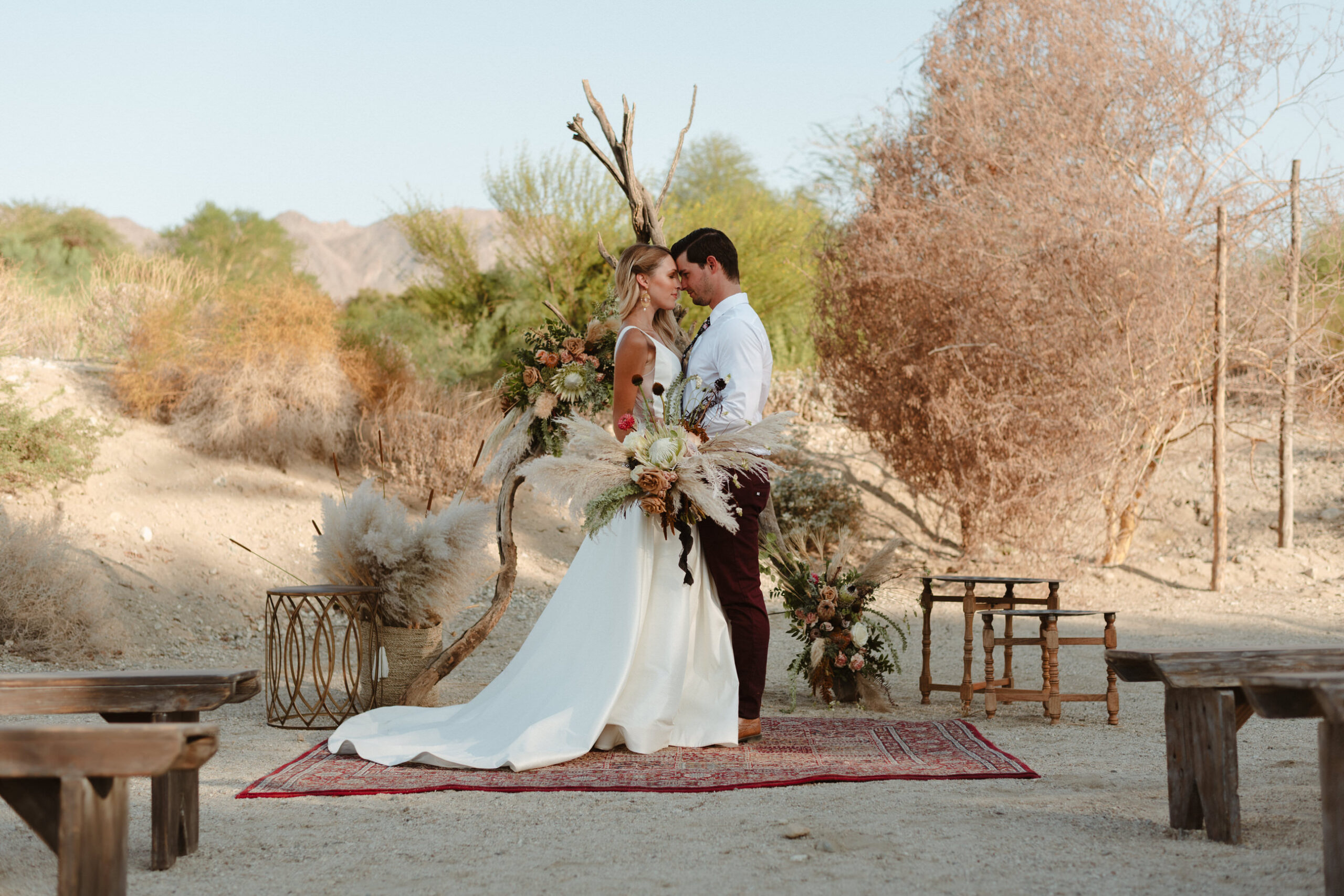 A couple standing at their ceremony during their Living Desert wedding in Palm Desert, CA.