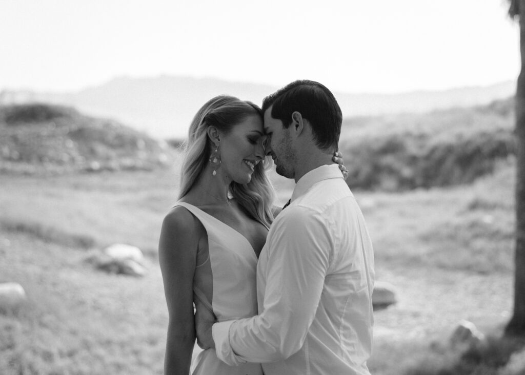 A couple taking photos during their Living Desert wedding in Palm Desert, CA.