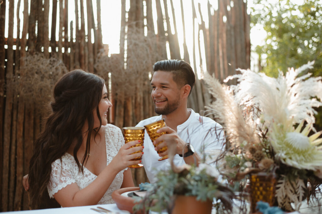 A couple taking photos during their Living Desert wedding in Palm Desert, CA.