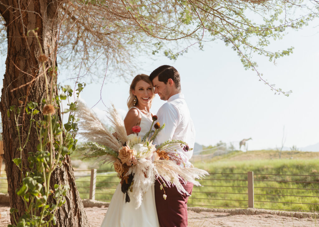 A couple taking photos during their Living Desert wedding in Palm Desert, CA.